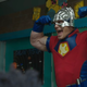 John Cena as Peacemaker, flexing in a classroom of schoolchildren.